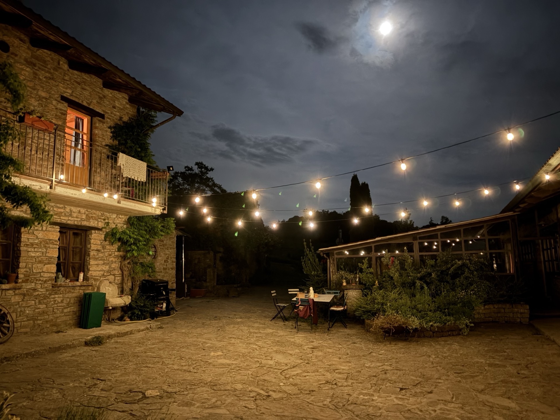 Courtyard at night with string lights